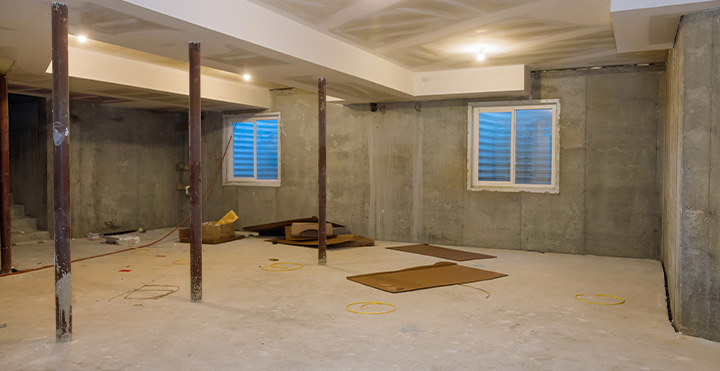 spacious room with brick wall and minimalistic storage spaces featuring a clean floor suitable for various activities including art projects and casual gatherings