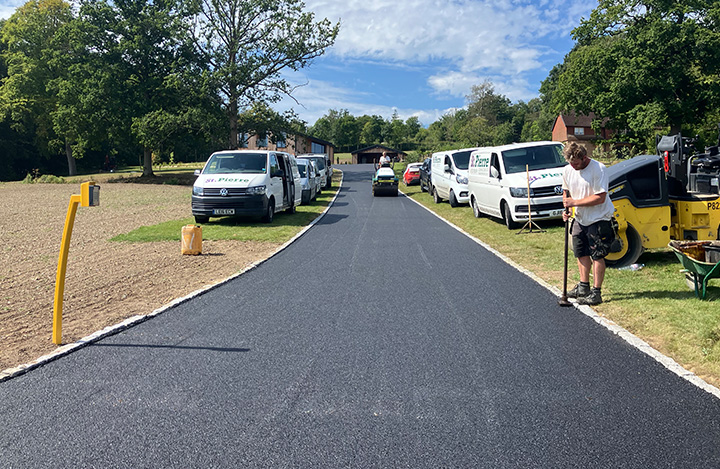 wooden pathway winding through garden with flowers and pond reflecting nature 3 design elements 3 tranquility 3 landscaping