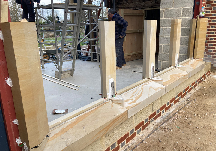 hands of a carpenter working on wood pieces with a clamp in a workshop focused on craftsmanship and precision in building projects